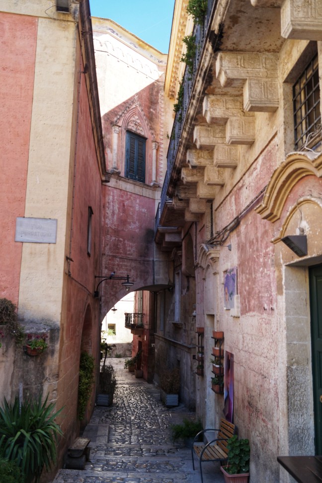 Pink narrow street in Matera Basilicata Italy