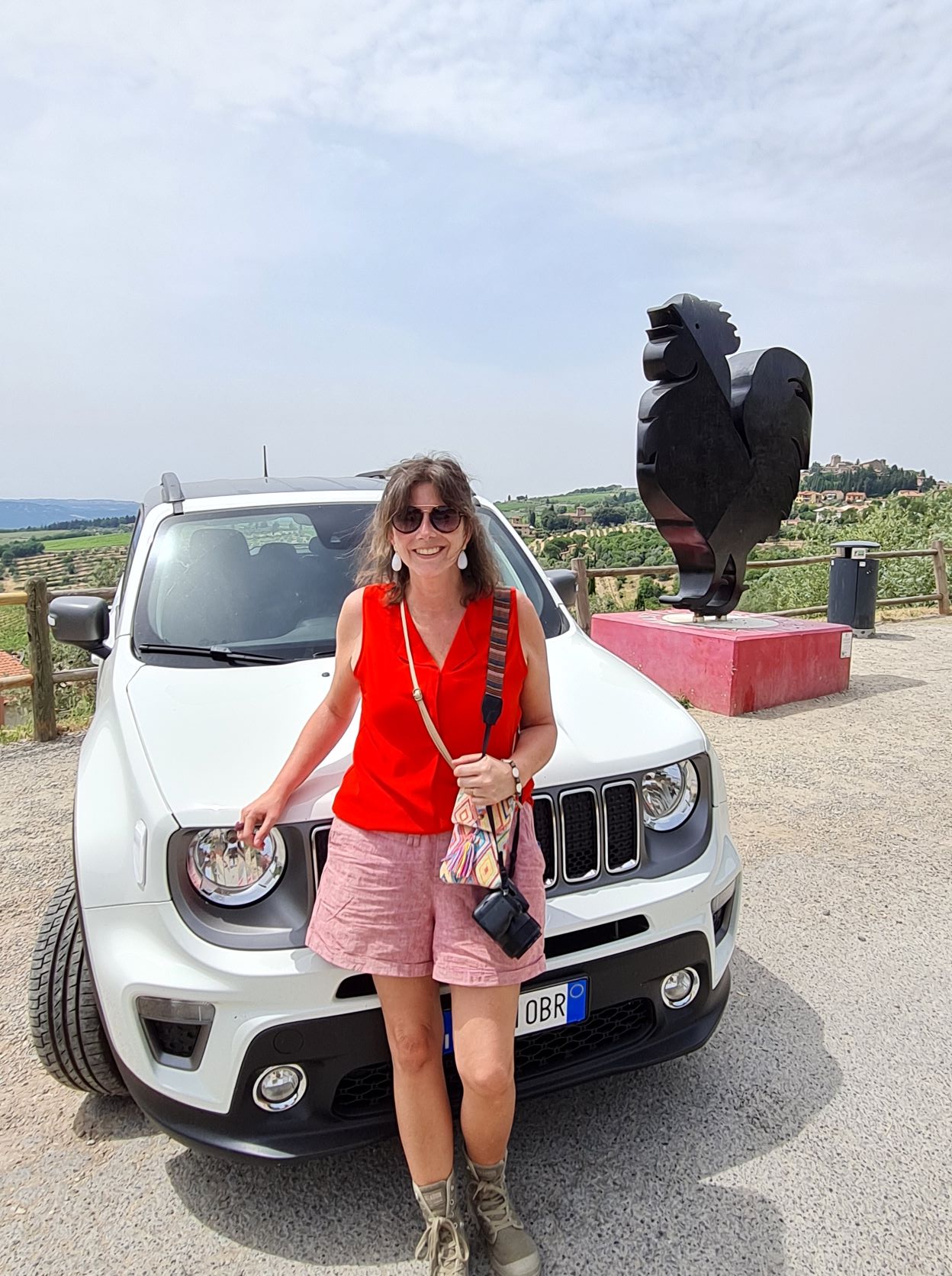 wom posing before white Jeep in Panzano Tuscany