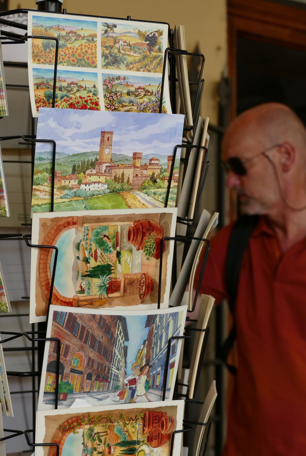 Man looking at postcards Tuscany
